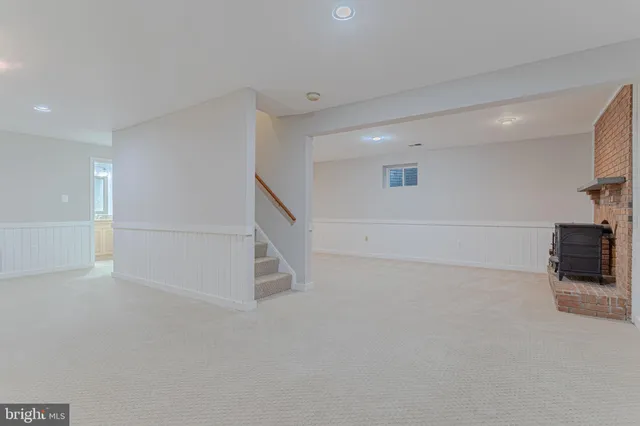 a view of a livingroom with an empty space and a fireplace