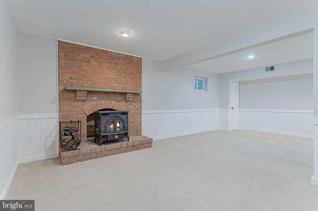 a view of an empty room with a fireplace