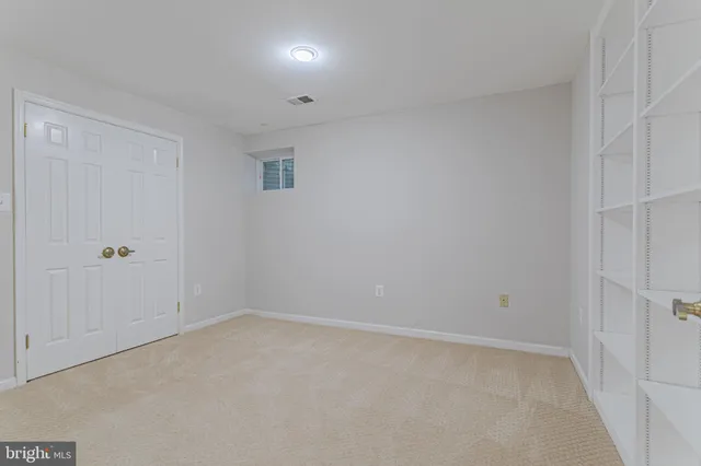 a bathroom with a granite countertop toilet sink and mirror
