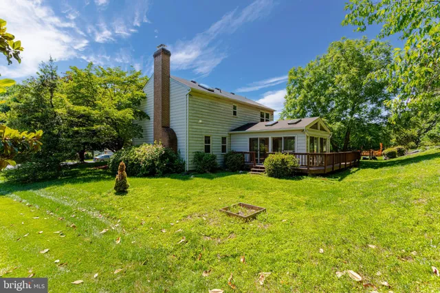 a front view of a house with yard and green space