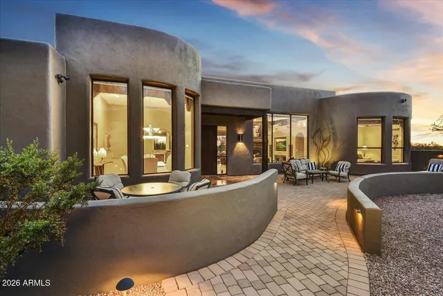 a living room with furniture and large windows