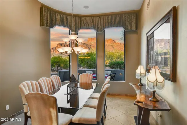 a dining room with furniture a chandelier and wooden floor