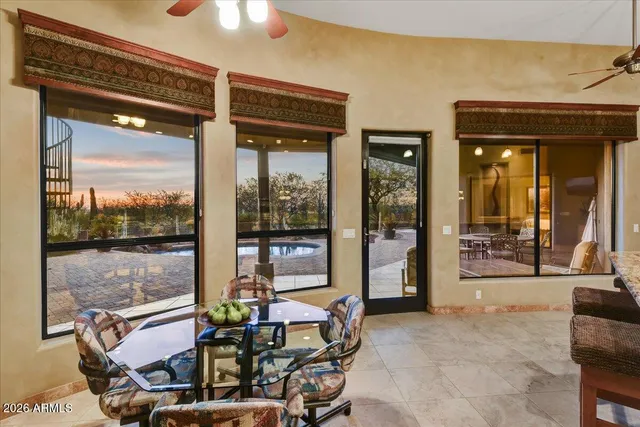 a living room with a large window and furniture
