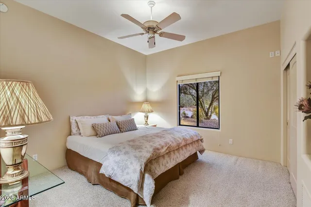 a bedroom with a bed and a painting on the wall