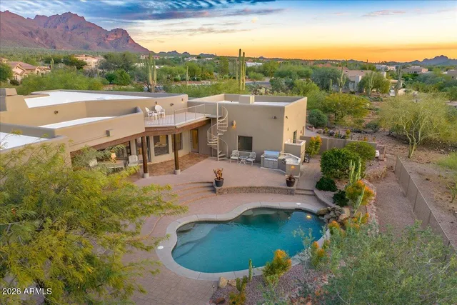 a view of a swimming pool with a patio and a yard