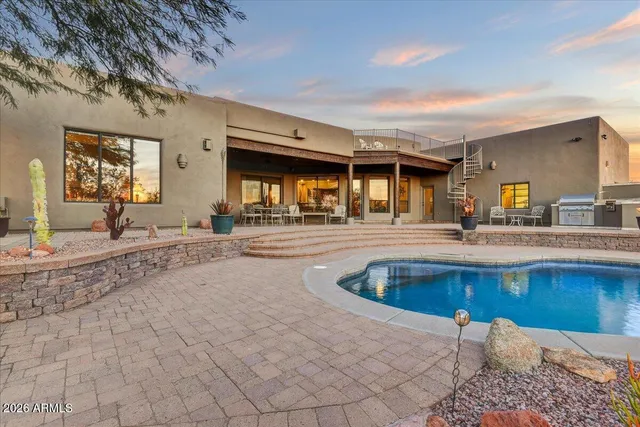 a large kitchen with stainless steel appliances a large counter top