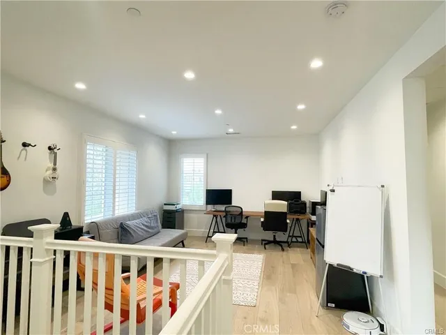 a living room with furniture a flat screen tv and a large window
