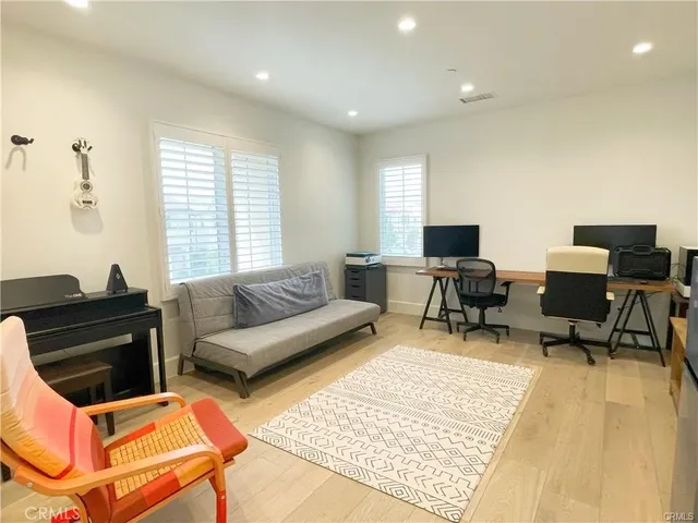 a living room with furniture rug and a window