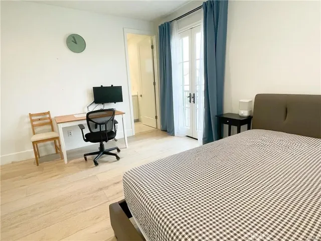 a bedroom with a bed and a desk