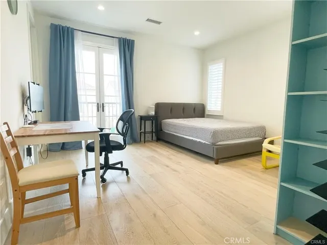 a bedroom with furniture and a large window