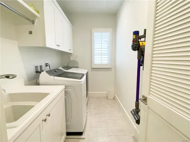 a utility room with sink dryer and washer