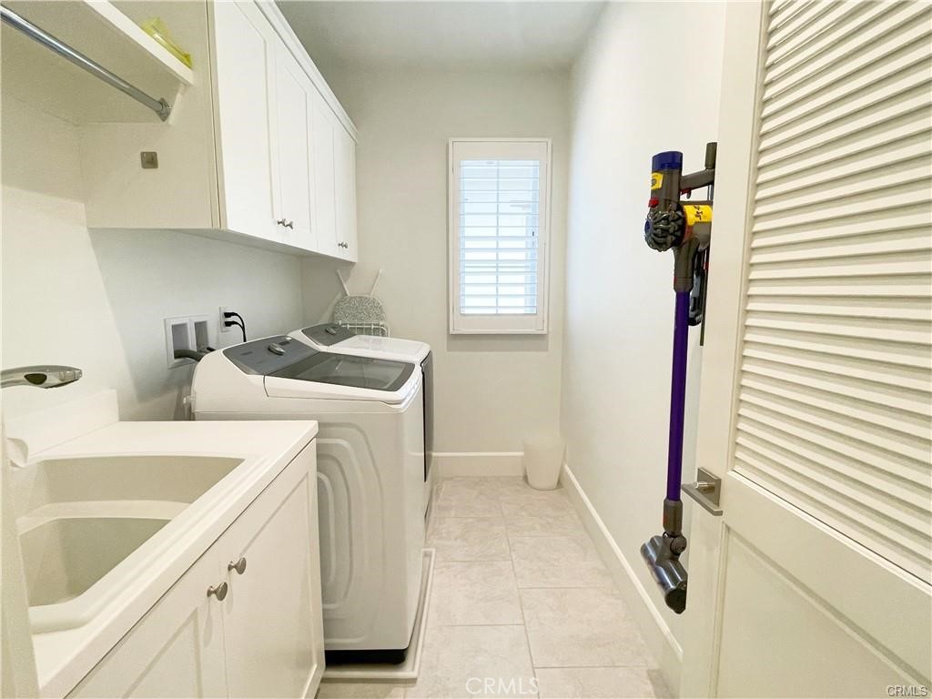 120 Statura Irvine, CA 92602 - Photo 16 of 27 a utility room with sink dryer and washer