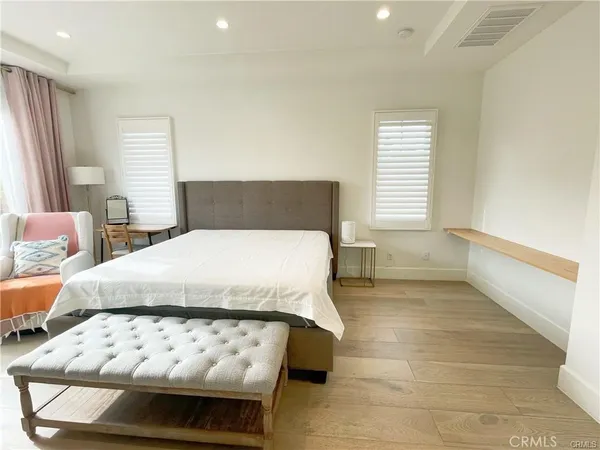 a large bed sitting in a room next to a window