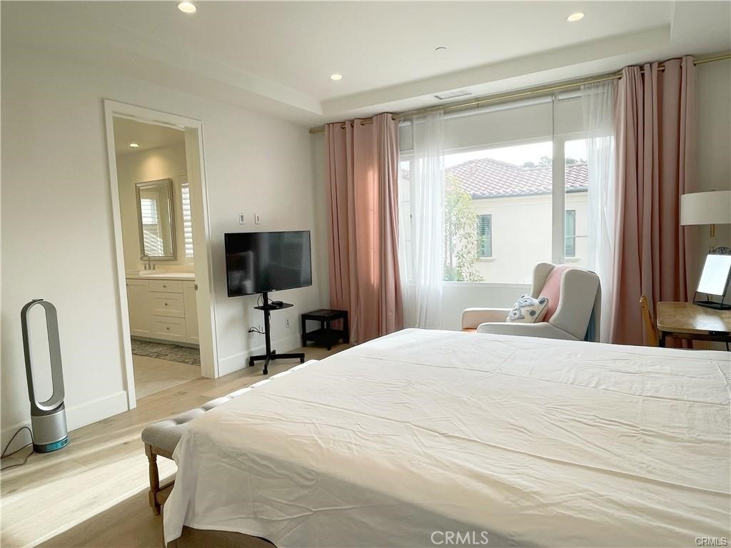 120 Statura Irvine, CA 92602 - Photo 20 of 27 a bedroom with a bed and a flat screen tv