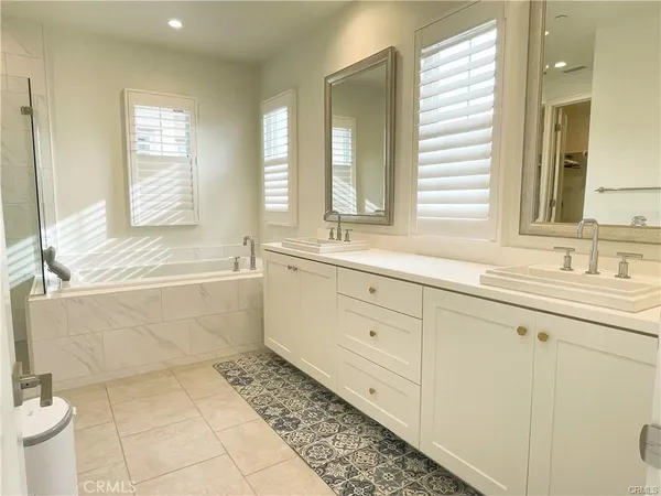 a bathroom with a sink mirror and a bathtub
