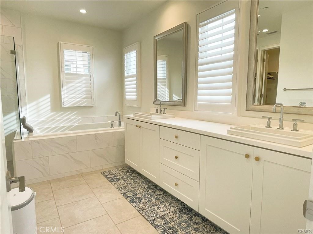 120 Statura Irvine, CA 92602 - Photo 21 of 27 a bathroom with a sink mirror and a bathtub