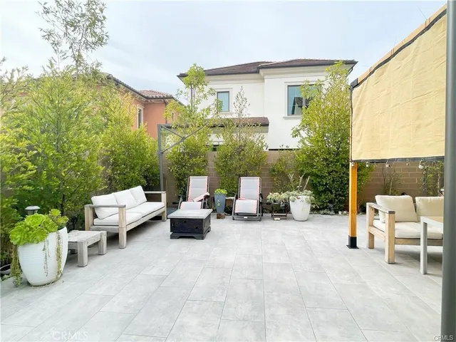 a view of a patio with couches and potted plants