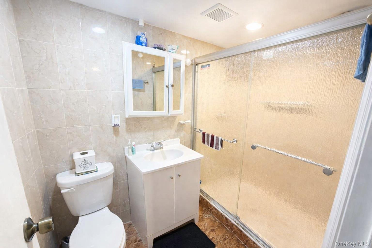 179-15 Selover Road Queens, NY 11434 - Photo 10 of 16 a bathroom with a sink a toilet and shower