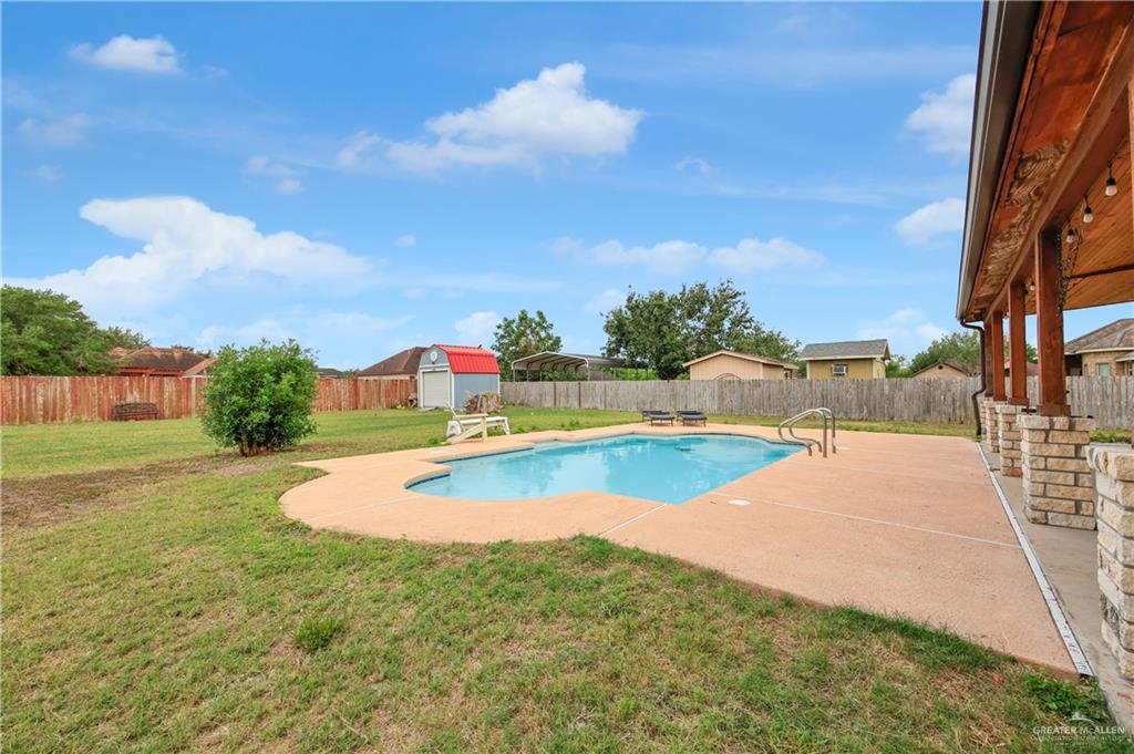 2005 Stuart Road Weslaco, TX 78599 - Photo 9 of 30 a view of a swimming pool with a yard