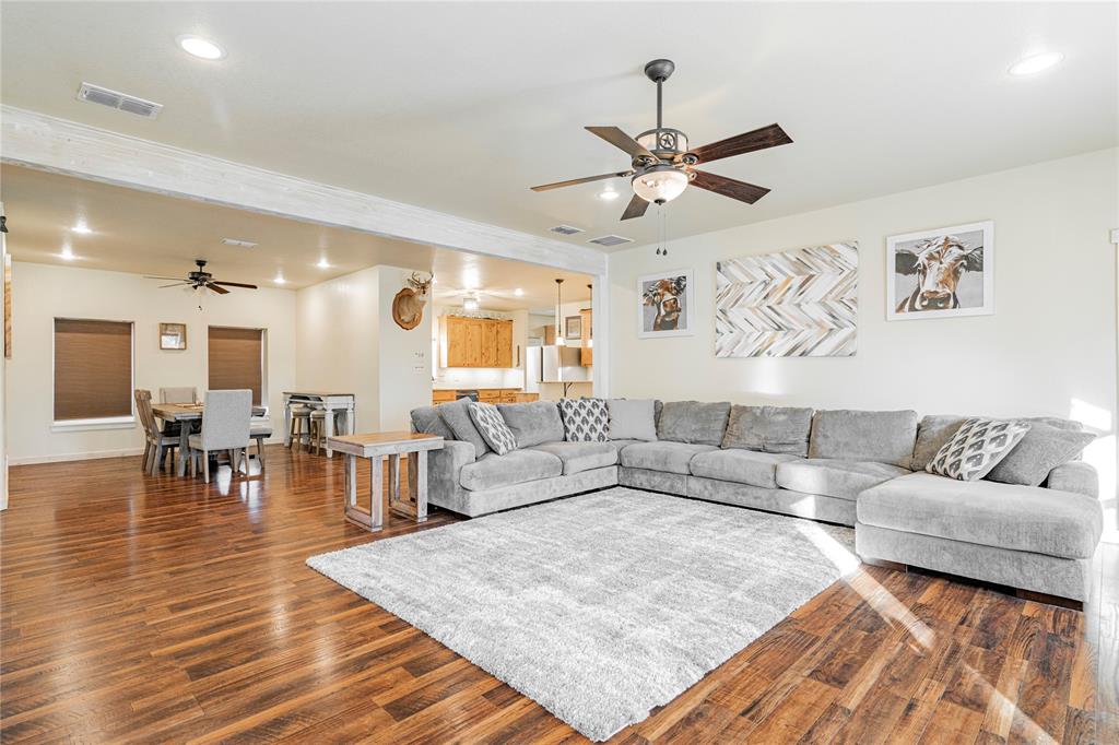 484 County Road 1886 Sunset, TX 76270 - Photo 1 of 1 Living room featuring dark hardwood / wood-style flooring and ceiling fan