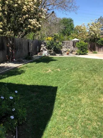 a view of a house with backyard porch and sitting area