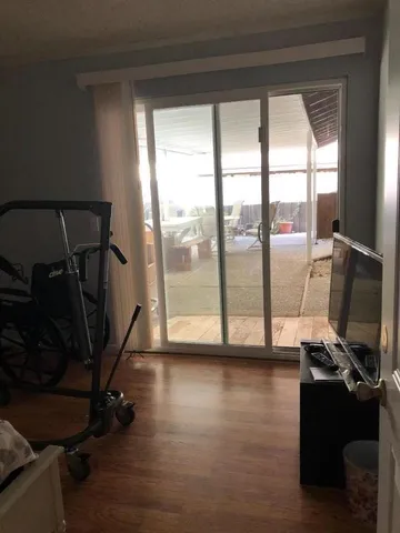 a view of a room with gym equipment and a large window