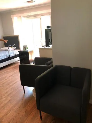 a living room with furniture window and wooden floor