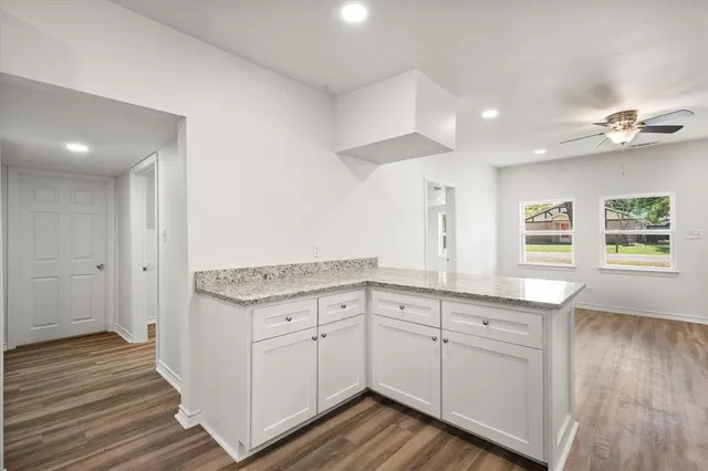 a spacious bathroom with a granite countertop sink and a mirror