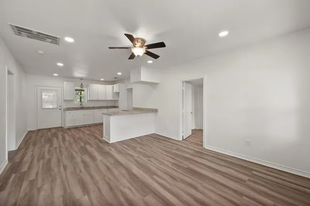 a view of kitchen with wooden floor and window