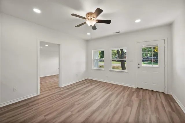 wooden floor in an empty room with a window