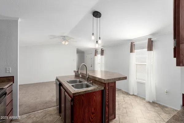a kitchen with stainless steel appliances granite countertop a sink refrigerator and cabinets