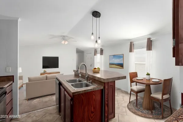 a kitchen with a sink a counter space and cabinets