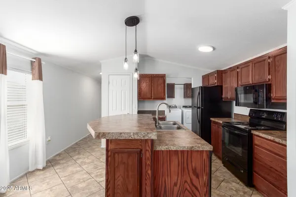 a view of a kitchen with a stove cabinets a ceiling fan and wooden floor