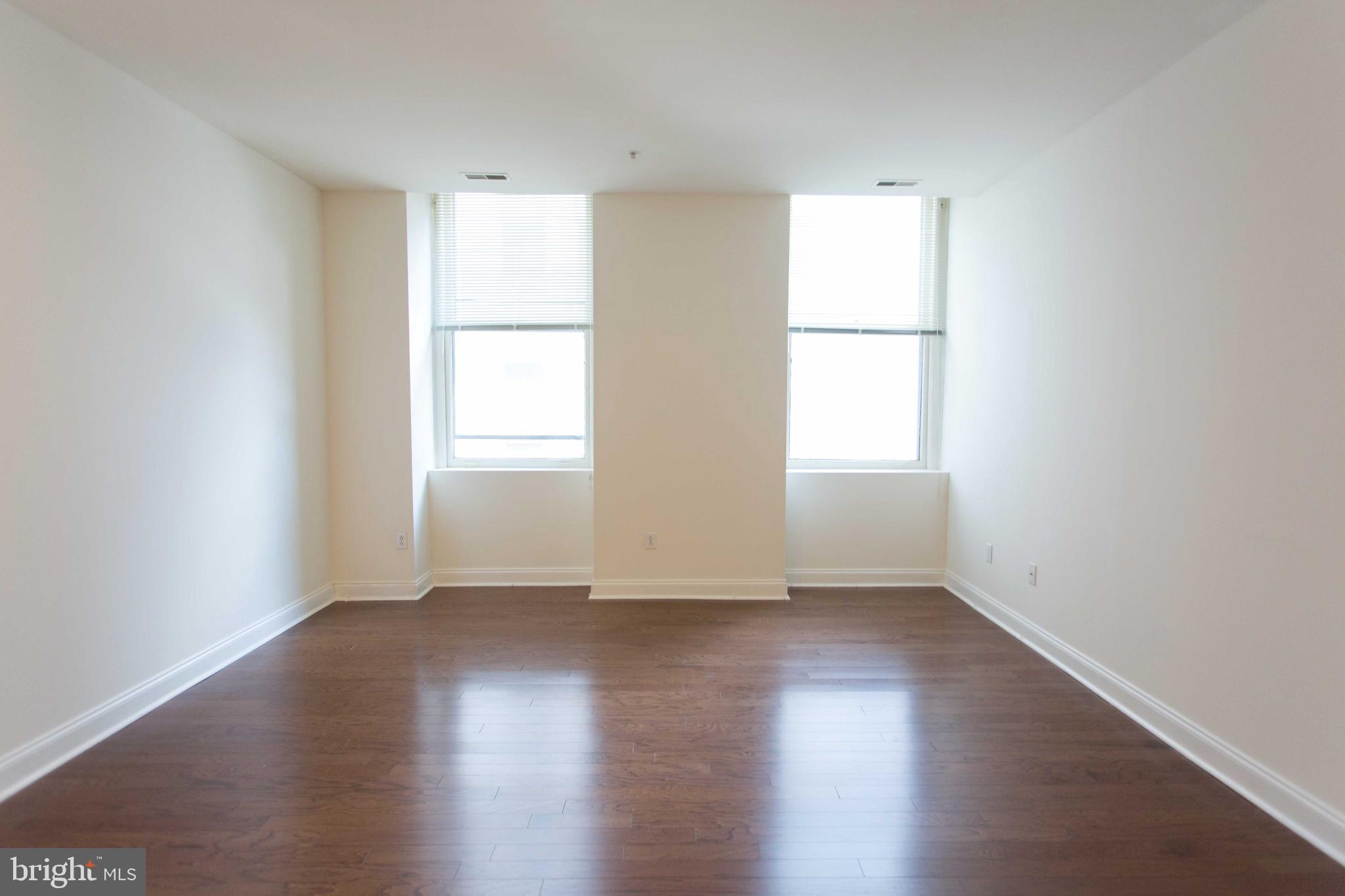 1600-2 Walnut Street, Unit 405 Philadelphia, PA 19103 - Photo 12 of 22 an empty room with wooden floor and windows