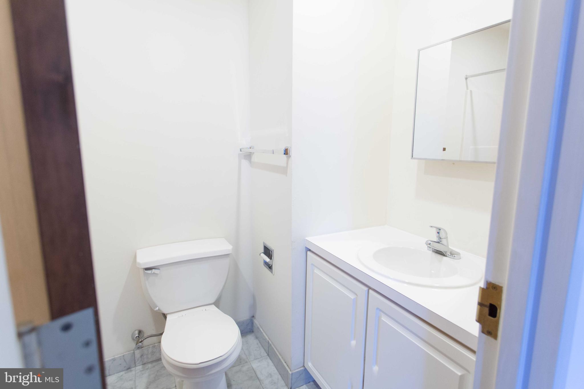 1600-2 Walnut Street, Unit 405 Philadelphia, PA 19103 - Photo 15 of 22 a white toilet sitting next to a bathroom sink