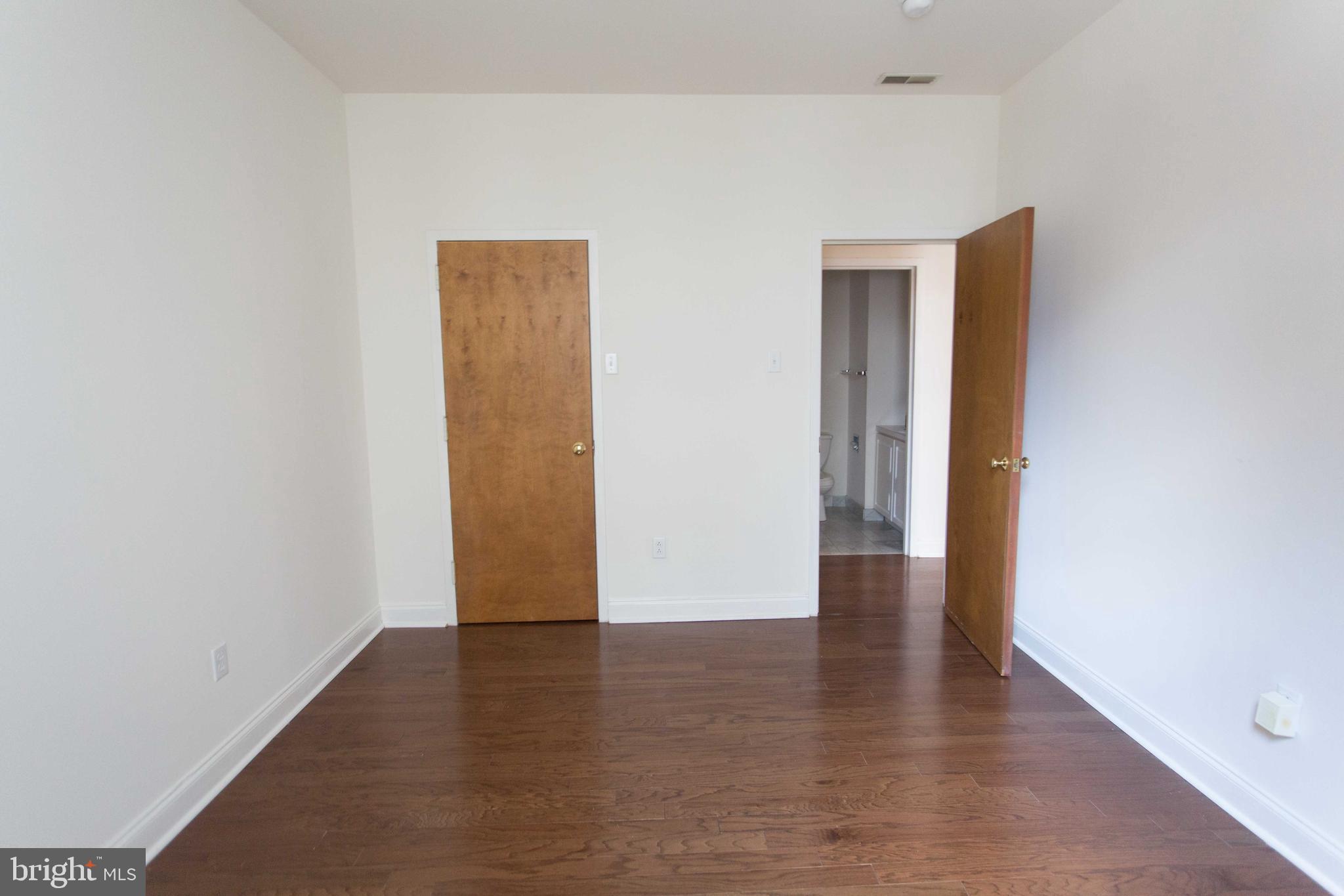 1600-2 Walnut Street, Unit 405 Philadelphia, PA 19103 - Photo 21 of 22 a view of an empty room with wooden floor and closet