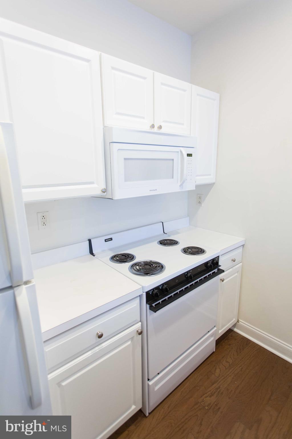 1600-2 Walnut Street, Unit 405 Philadelphia, PA 19103 - Photo 9 of 22 a stove top oven sitting inside of a kitchen