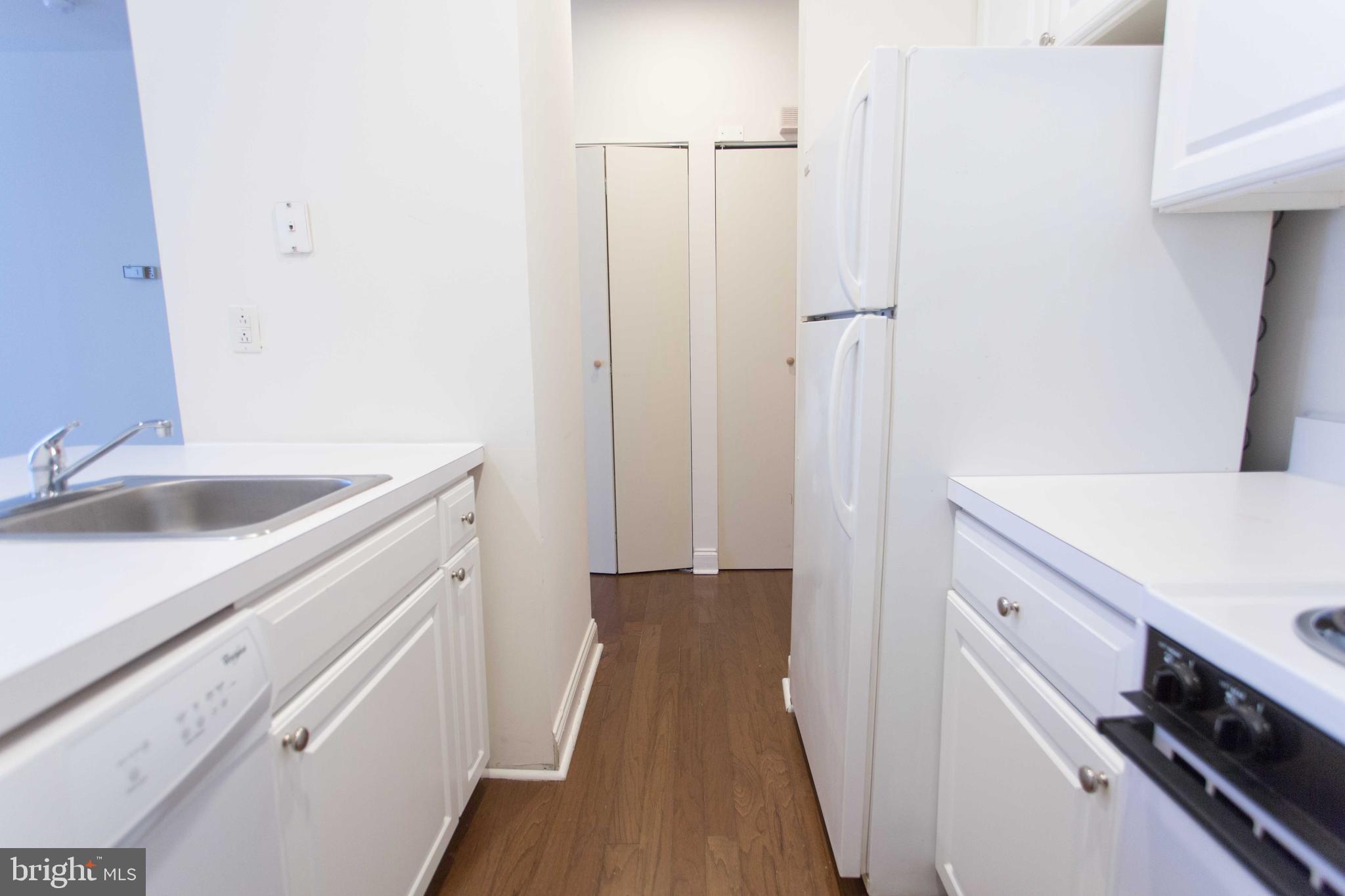 1600-2 Walnut Street, Unit 405 Philadelphia, PA 19103 - Photo 10 of 22 a kitchen with a sink and a refrigerator