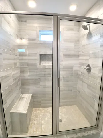 a bathroom with a glass shower door
