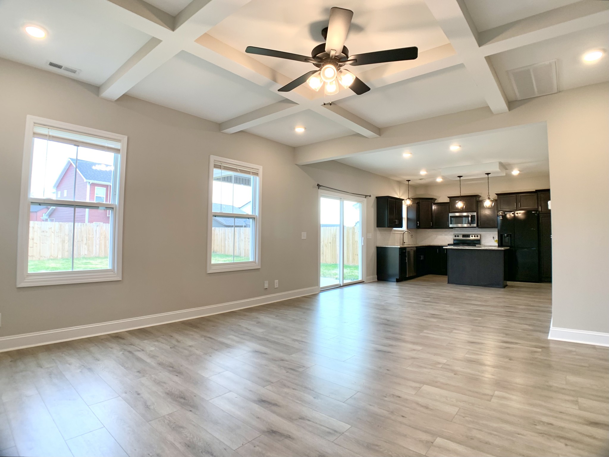 208 Copeland Road Clarksville, TN 37042 - Photo 4 of 35 a view of an empty room with wooden floor and a kitchen