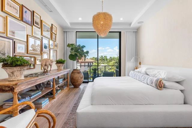 a bed room with a bed and a chandelier