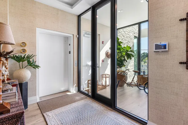 a view of a hallway and a livingroom with furniture