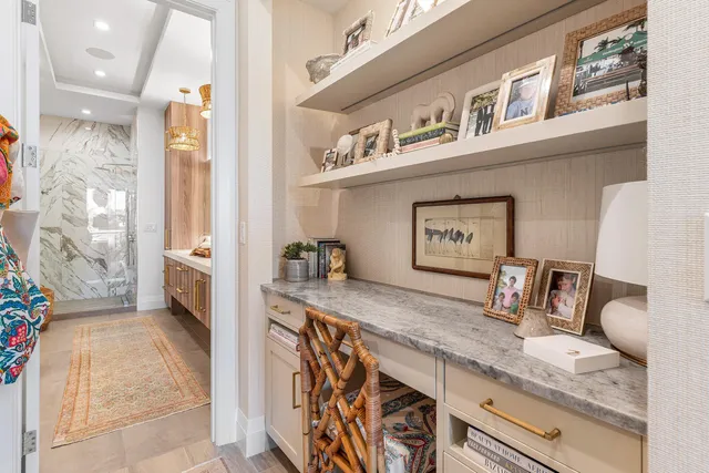 a view of a hallway with granite countertop a couch and a potted plant