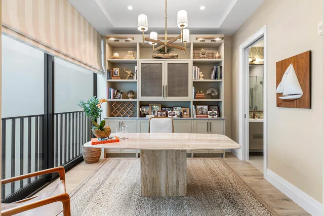 a view of a dining room with balcony furniture and chandelier