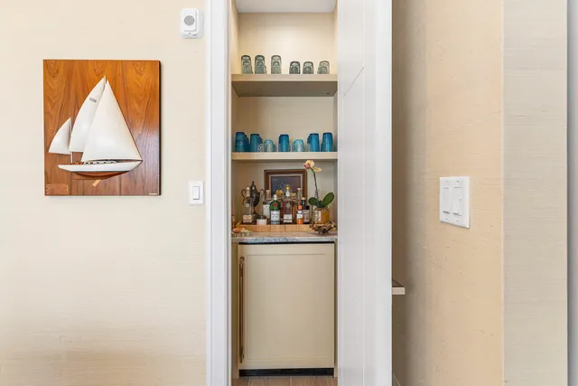 a view of a hallway with wooden floor and a cabinet