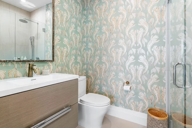 a bathroom with a sink a toilet and a mirror