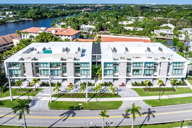 a view of building with garden space and ocean view