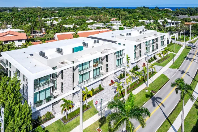 an aerial view of a residential houses with city view