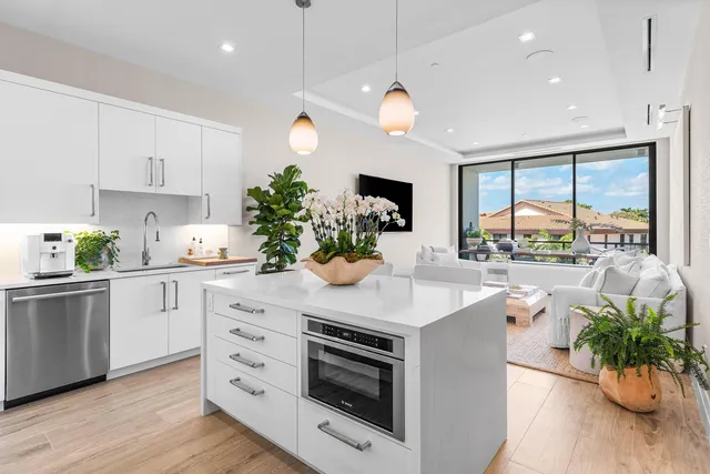 a kitchen with stainless steel appliances kitchen island a large island in the center