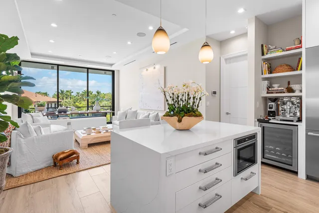 a kitchen that has a lot of cabinets in it and wooden floor